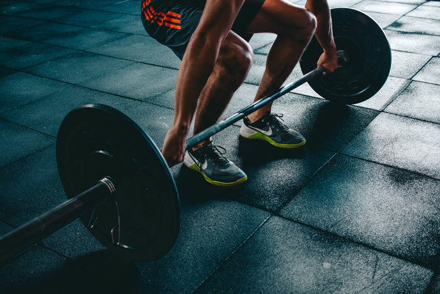 Athlete preparing to deadlift a barbell, representing the strength and recovery goals associated with MK-677