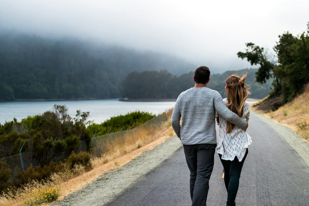 Couple walking together on a lakeside path, a daily habit that supports healthy blood pressure