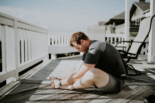 Man practicing yoga, representing a weight-loss and wellness journey