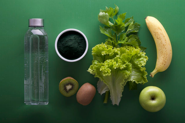 Healthy foods and wellness supplements arranged on a green background
