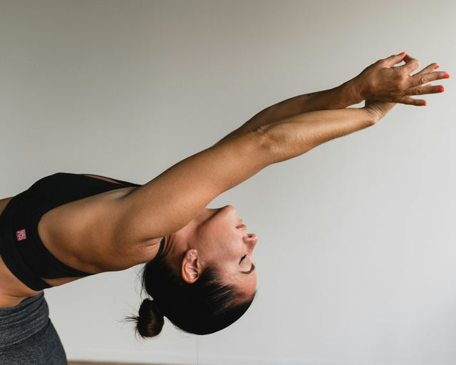 Woman stretching her arms, representing a recovery routine