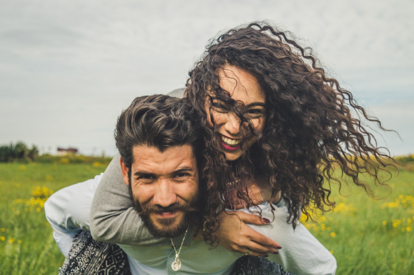 Two people relaxing together in a bright sunlit space, representing intimate connection and wellness