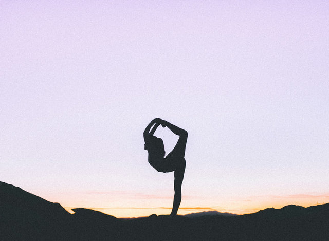 Woman standing balanced on one leg, representing physical therapy and mobility