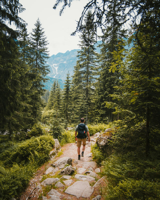 Man in athletic wear reflecting on health and energy levels outdoors