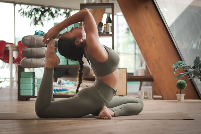 Woman doing yoga, representing fitness and wellness