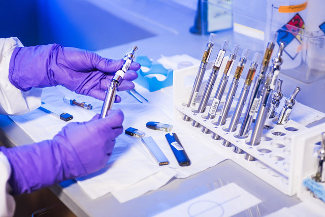 Person holding a medication vial