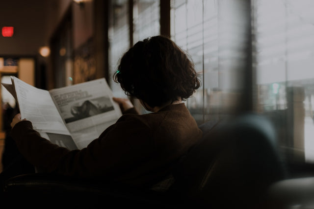 Woman sitting by a window reading