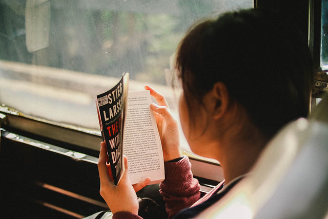 Woman reading a book at home