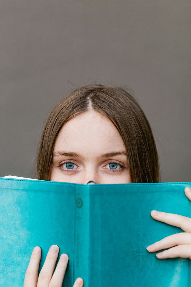 Woman reading, comparing telehealth options