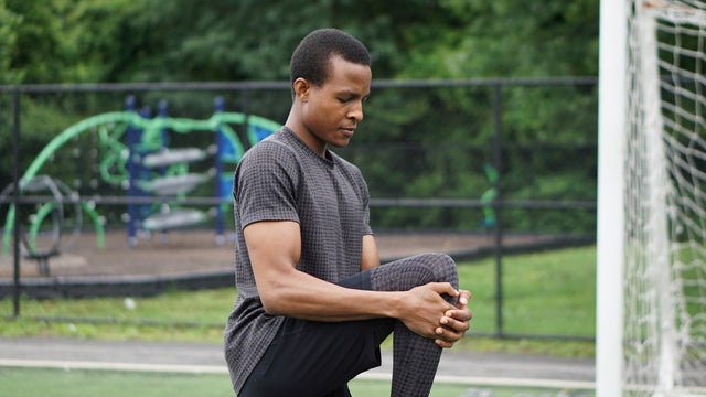 Man sitting on concrete pavement, representing mens health and wellness
