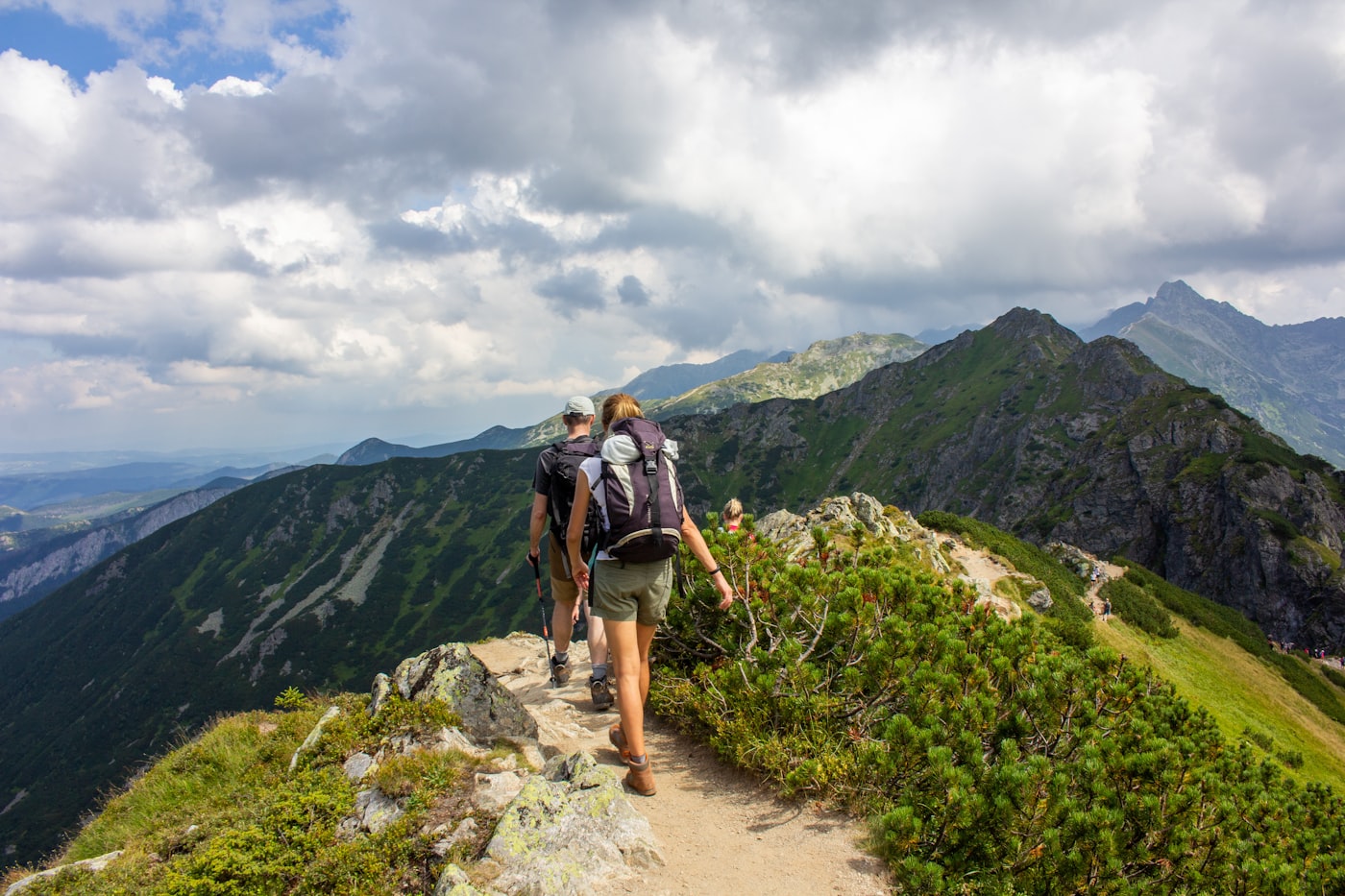 Active hikers on a mountain trail representing longevity and active aging