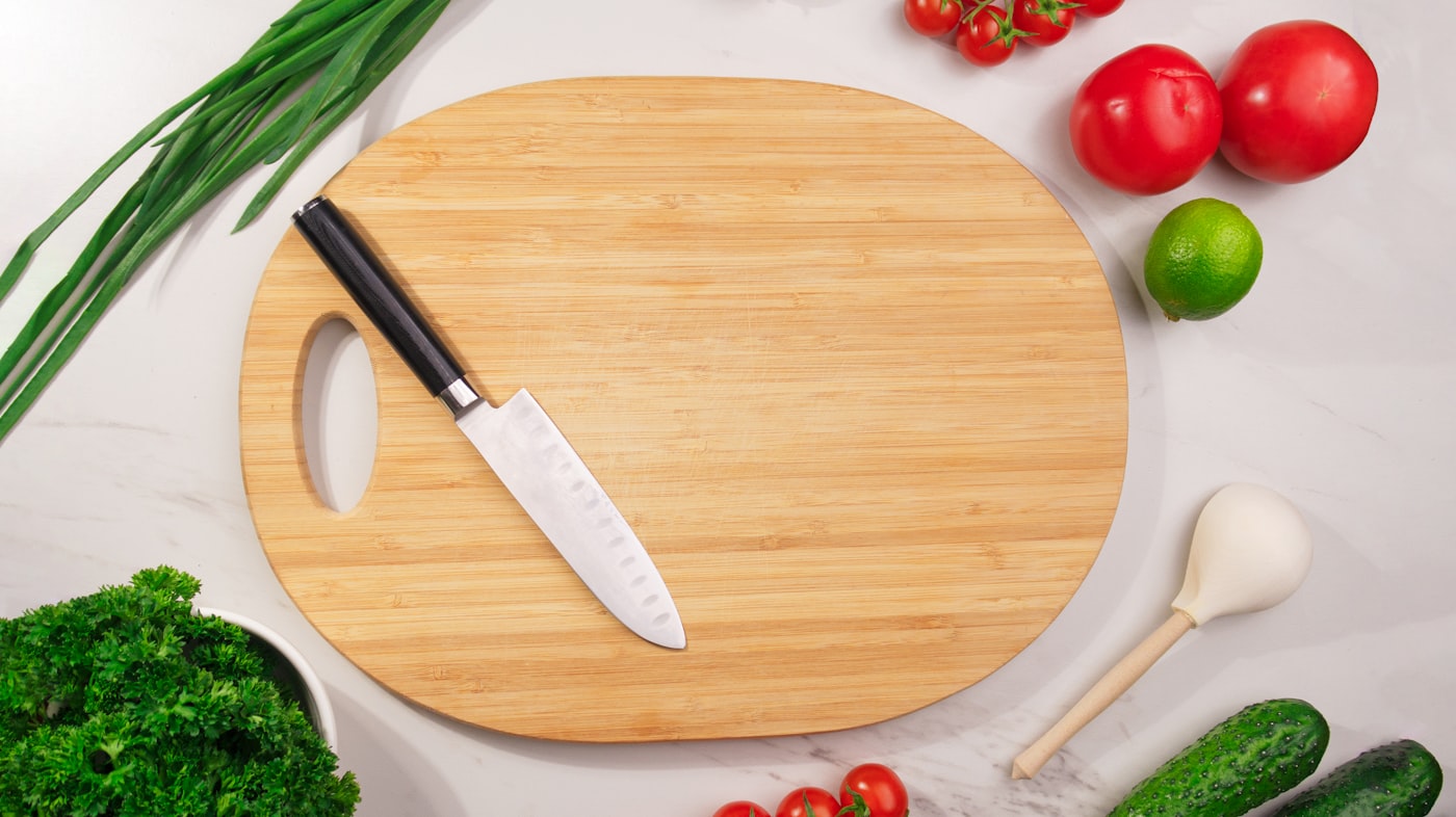 A wooden cutting board with fresh vegetables