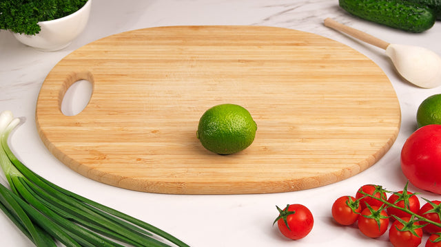 A cutting board with fresh vegetables and lime