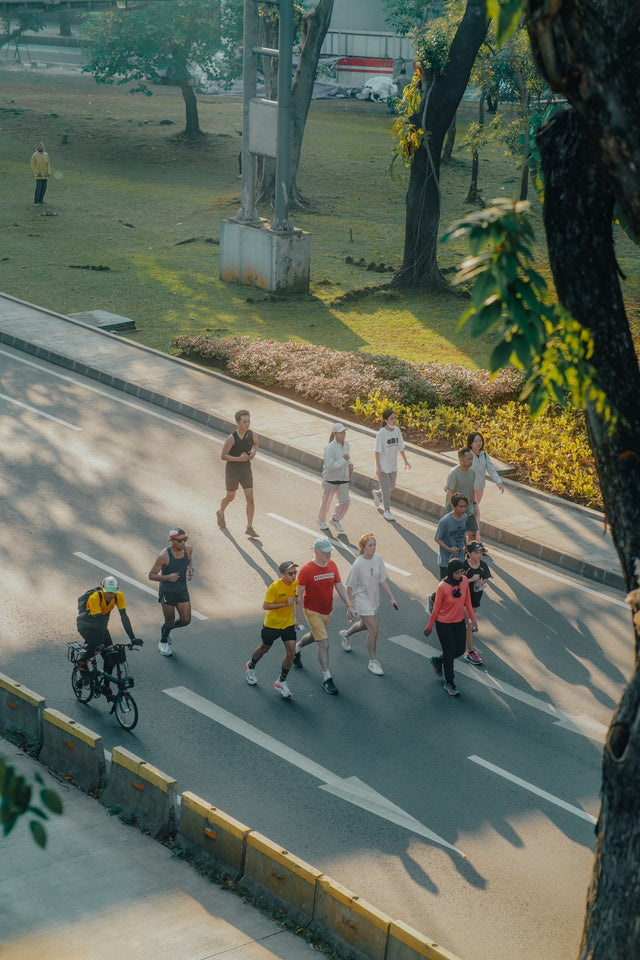 a group of people running on a road