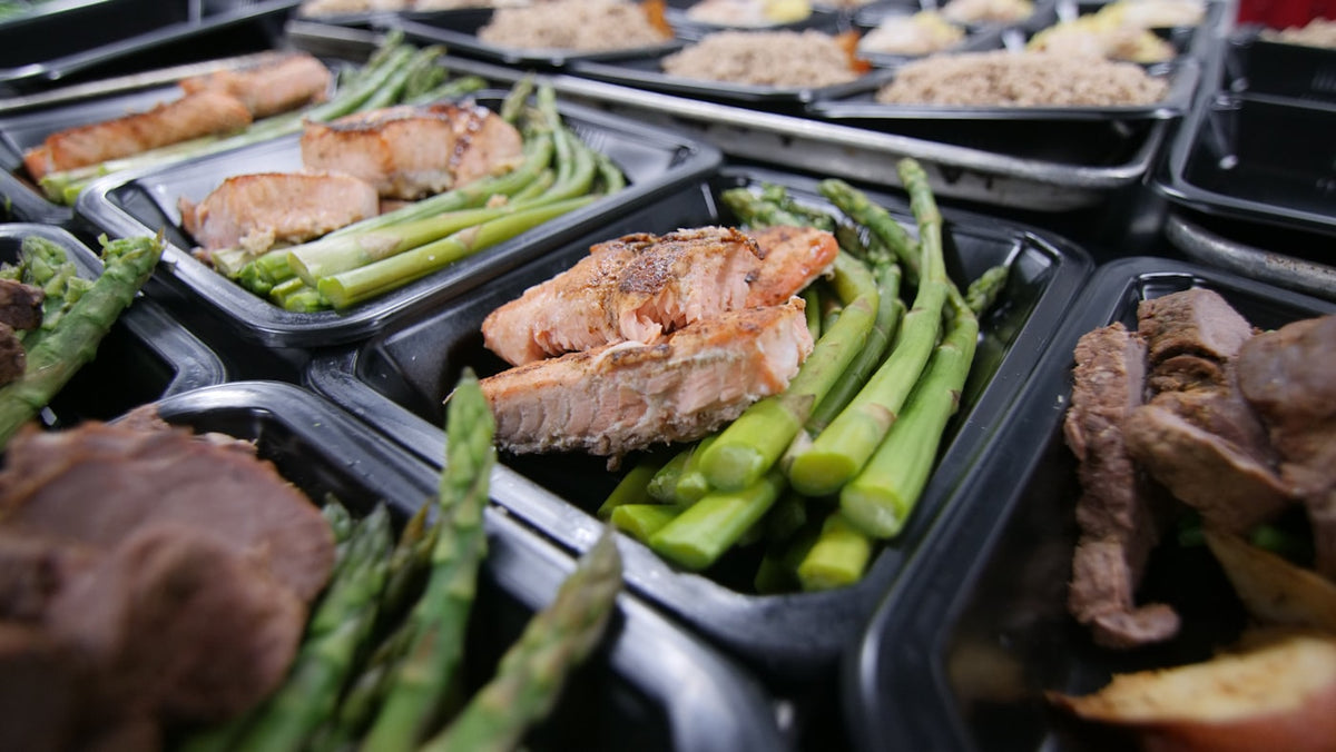 a group of meats and vegetables on a grill