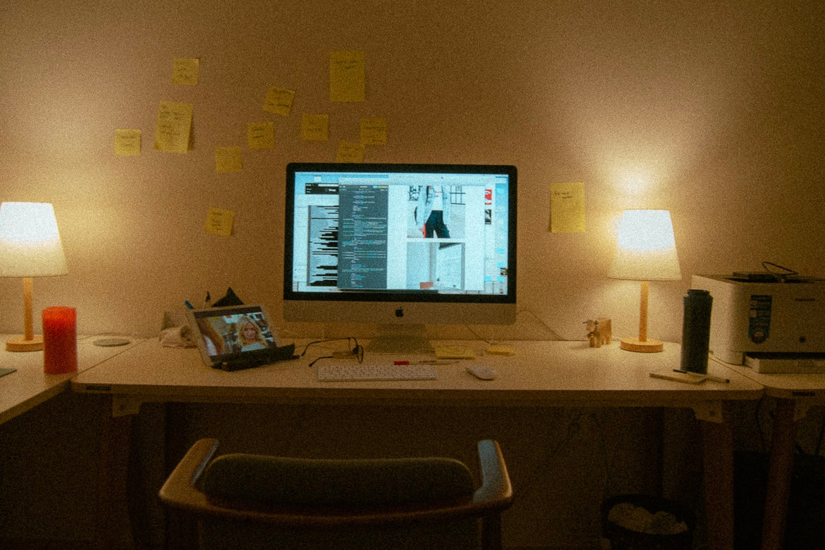 Desk workspace with laptop and lamp, representing telehealth research