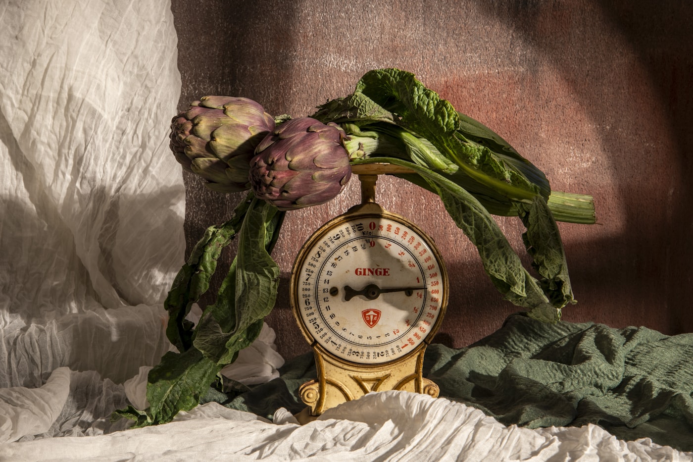 Artichokes rest upon an old-fashioned scale.