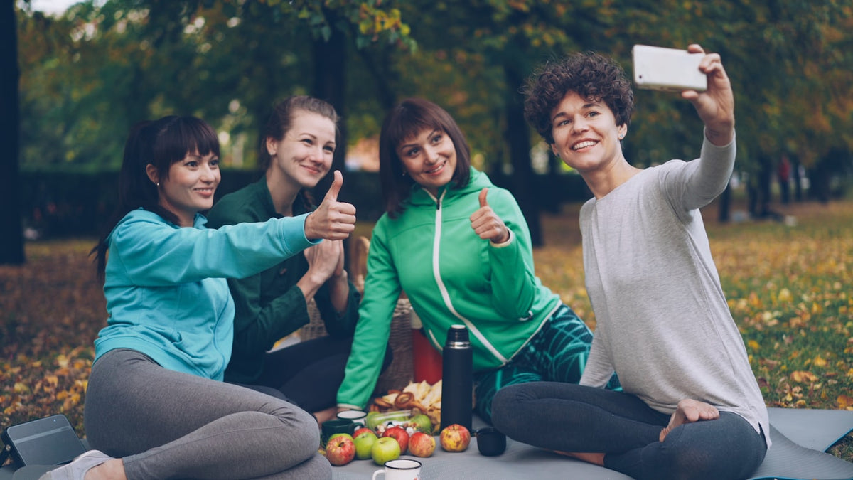 Four friends taking a selfie in a park