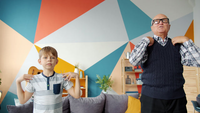 Grandfather and grandson doing exercises together at home.