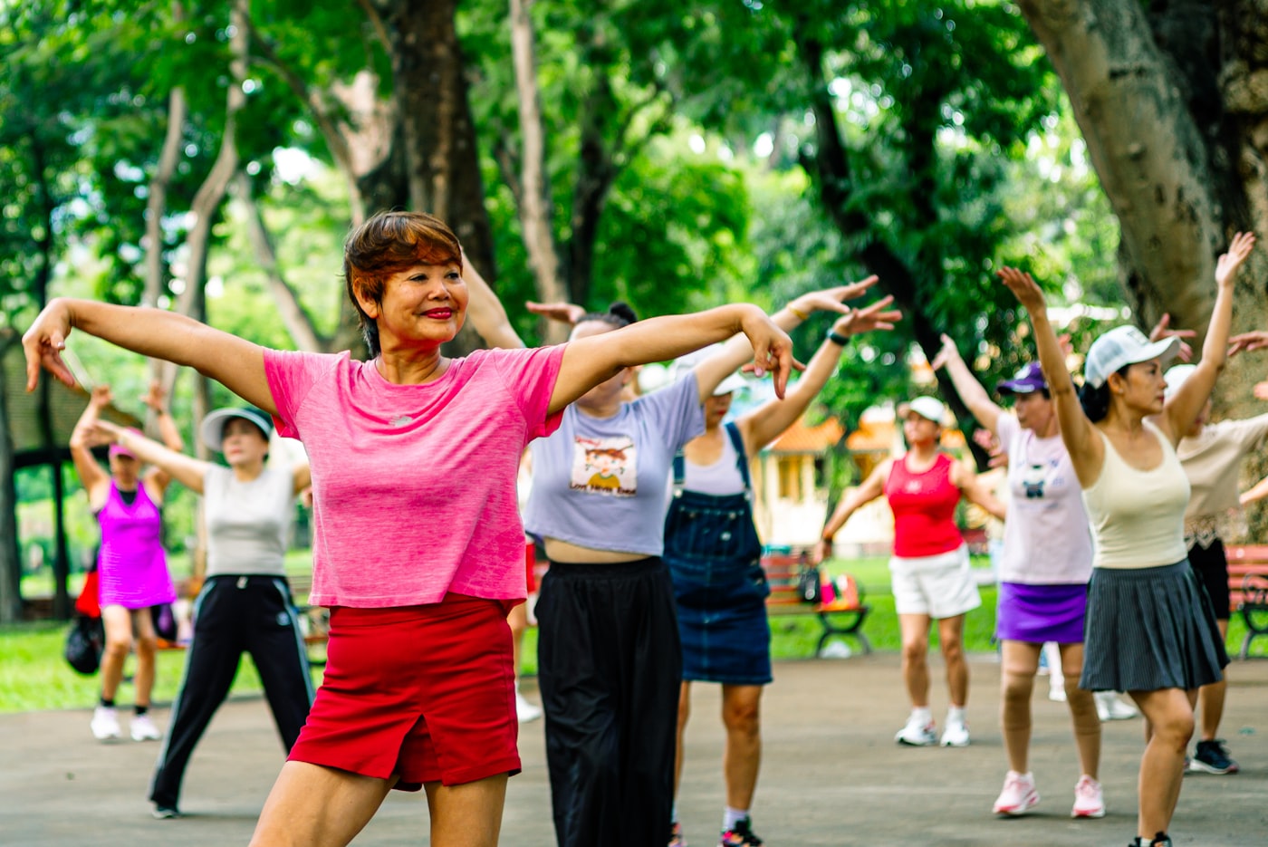 Group of women exercising together outdoors, representing community wellness