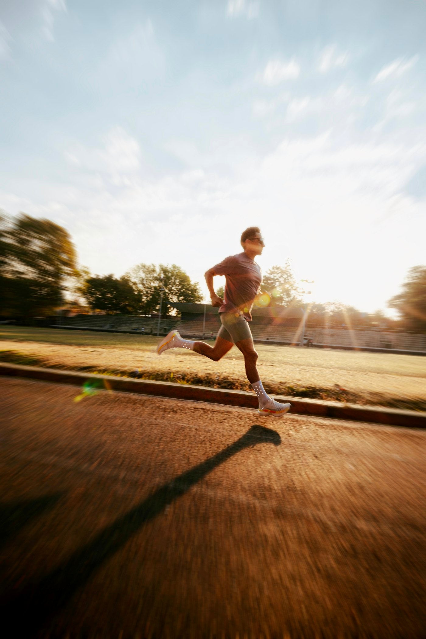 Man running on outdoor track at sunrise for GLP-1 weight loss journey