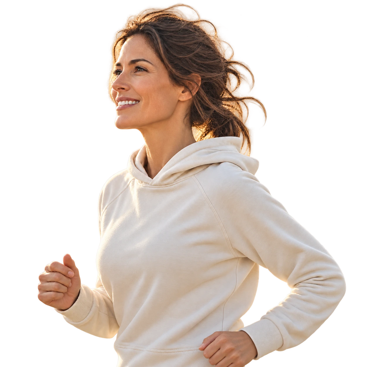 An active woman in a cream hoodie, smiling in warm daylight